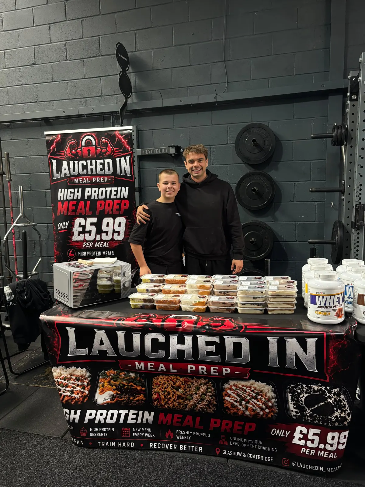 Lauchlan and his younger brother behind the Lauched In stall at a gym